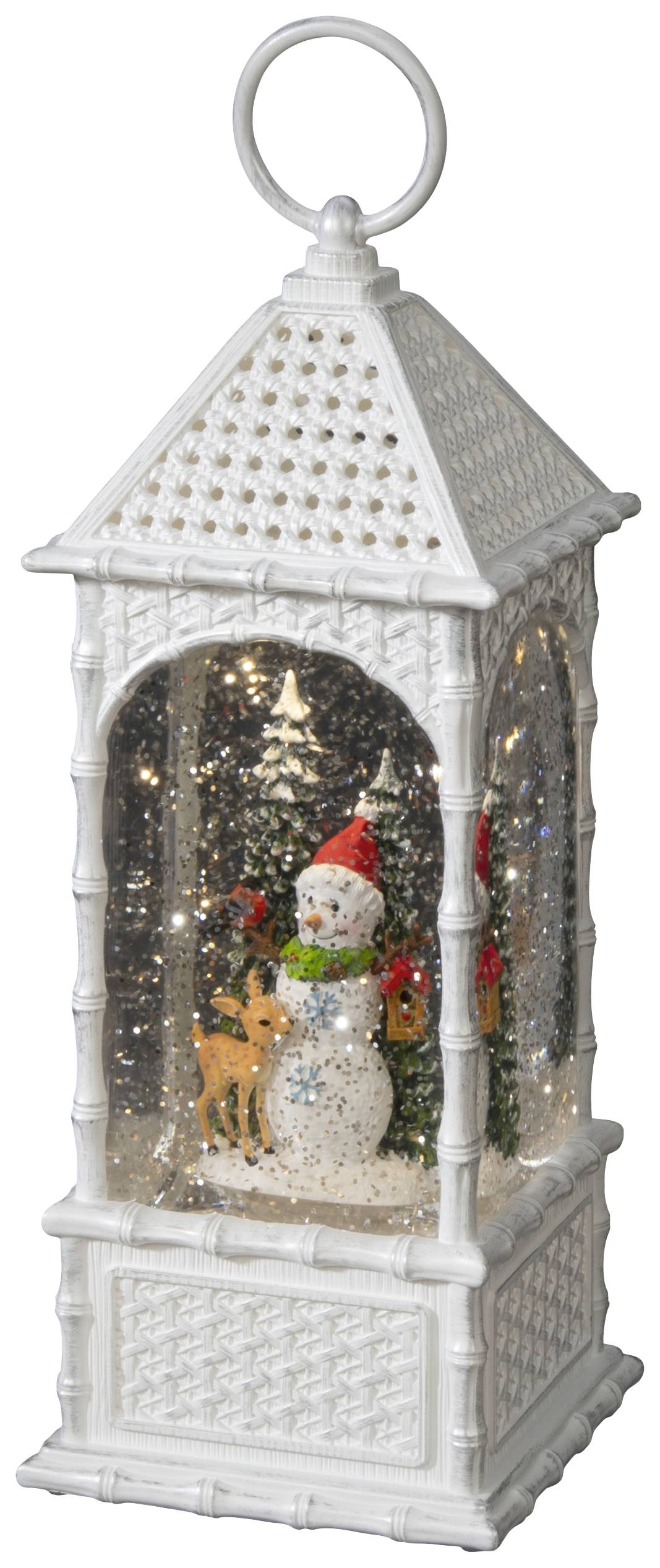 Eine weiße Laterne mit einem Schneemann im Inneren, umgeben von schimmernden Glitzerpartikeln und einem kleinen Rentier.