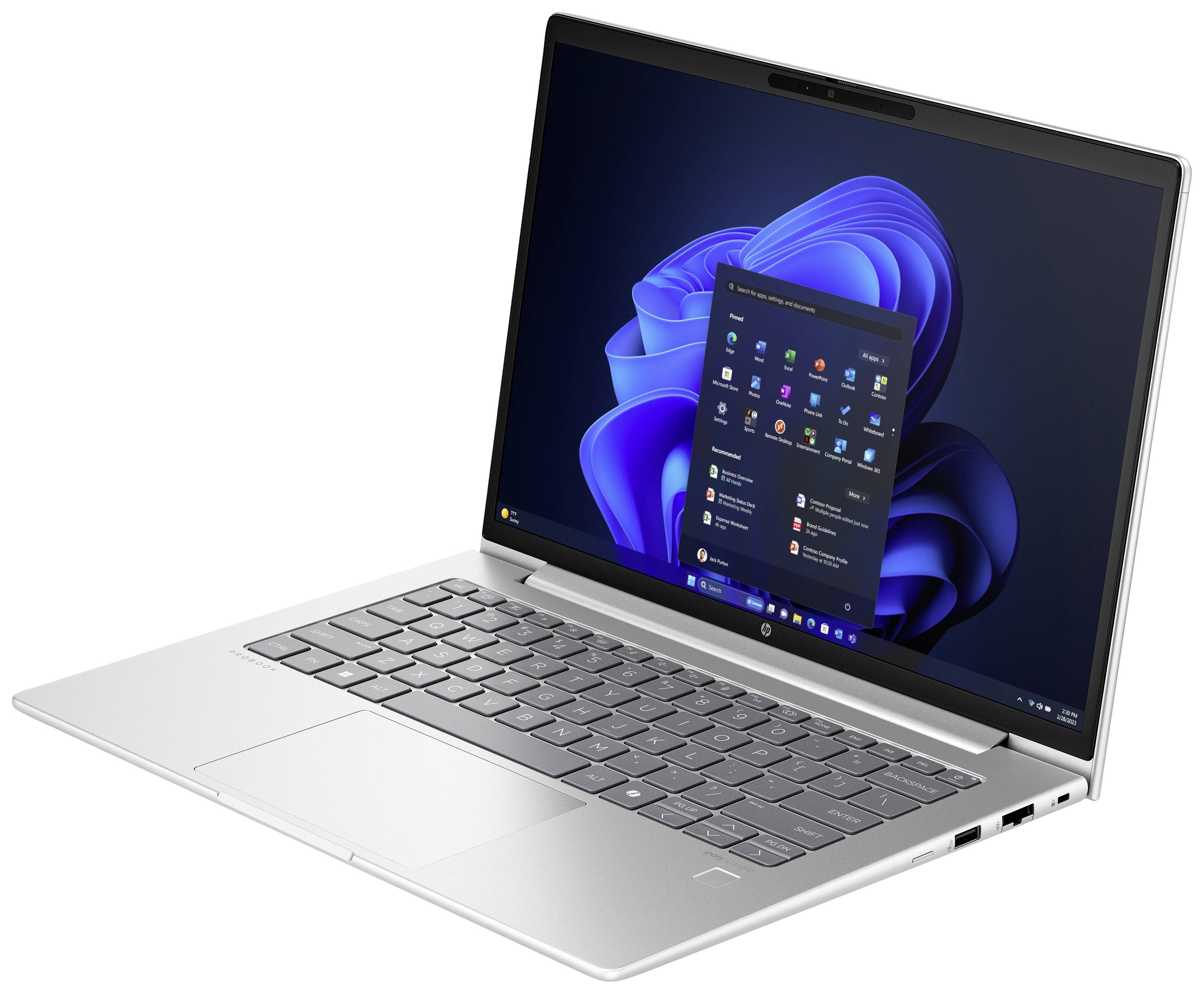 Ein silberner Laptop mit geöffneter Windows-Oberfläche zeigt das Startmenü auf einem Tisch.