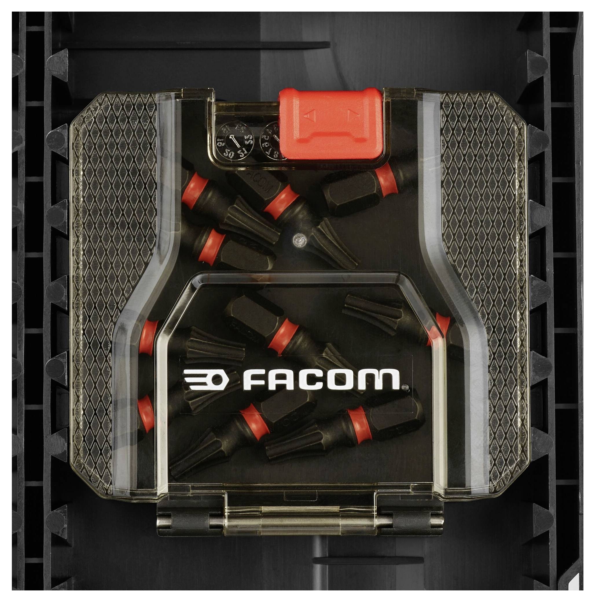 Eine schwarze Box mit mehreren kleinen roten und schwarzen Werkzeugteilen, beschriftet mit 'FACOM'.
