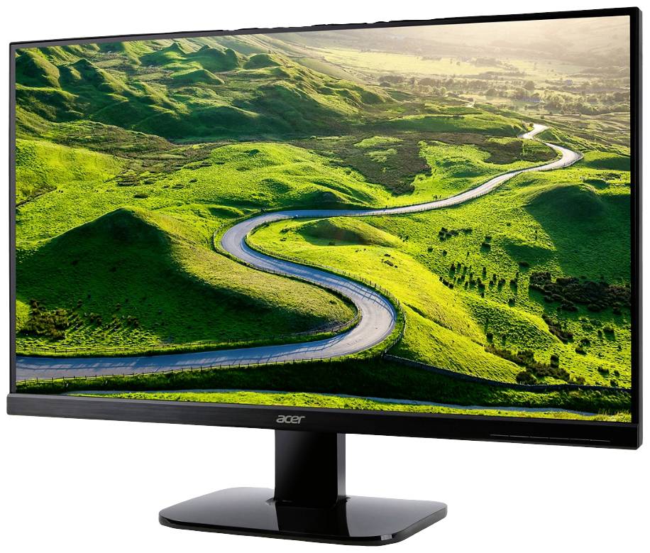 Ein Computermonitor zeigt eine Landschaft mit einer kurvenreichen Straße, die sich durch grüne Hügel windet, unter einem klaren Himmel.