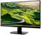 Ein Computermonitor zeigt eine Landschaft mit einer kurvenreichen Straße, die sich durch grüne Hügel windet, unter einem klaren Himmel.