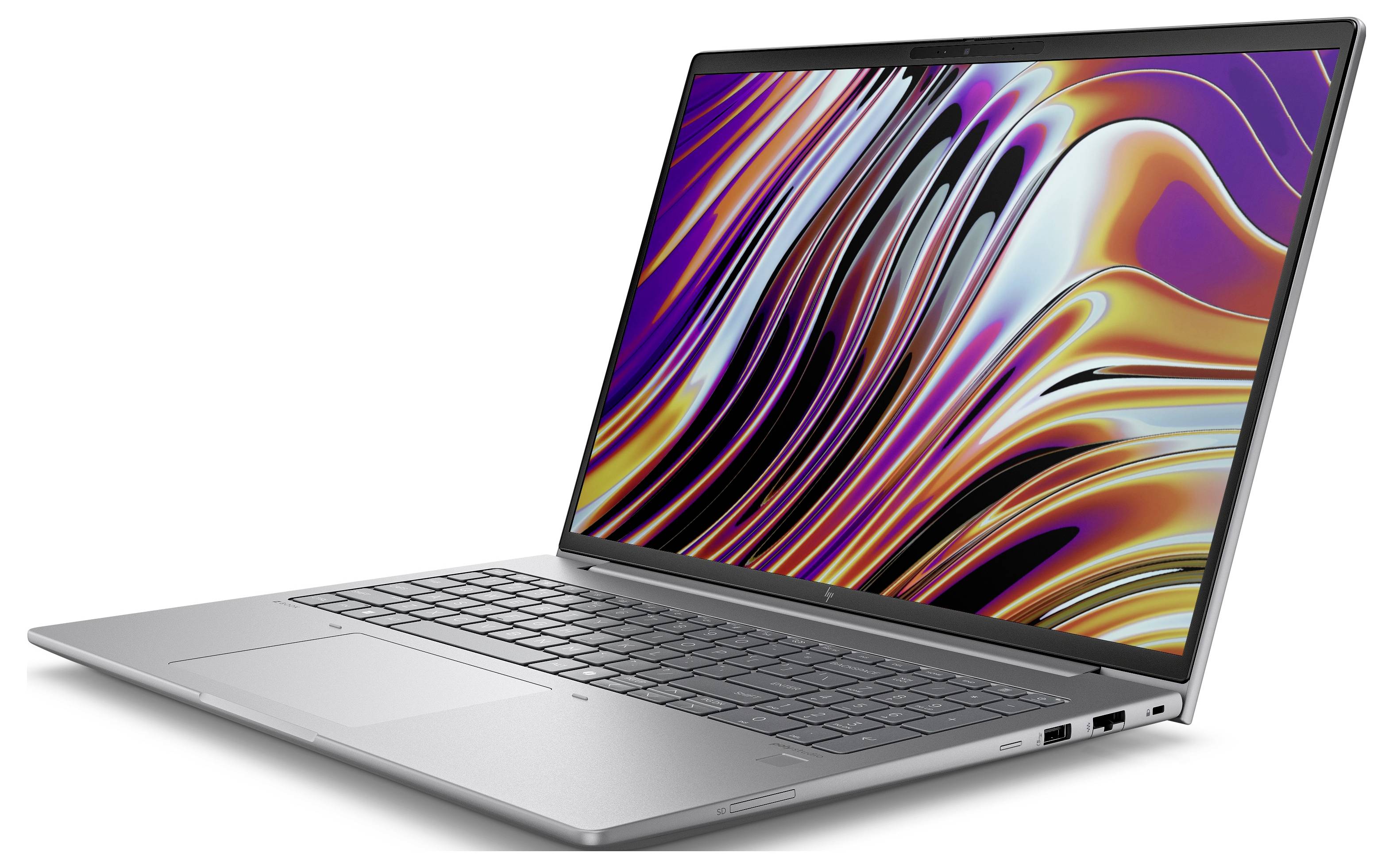 Ein silberner Laptop mit geöffneter Anzeige, die ein buntes, wellenförmiges Muster zeigt. Die Tastatur und das Trackpad sind sichtbar.