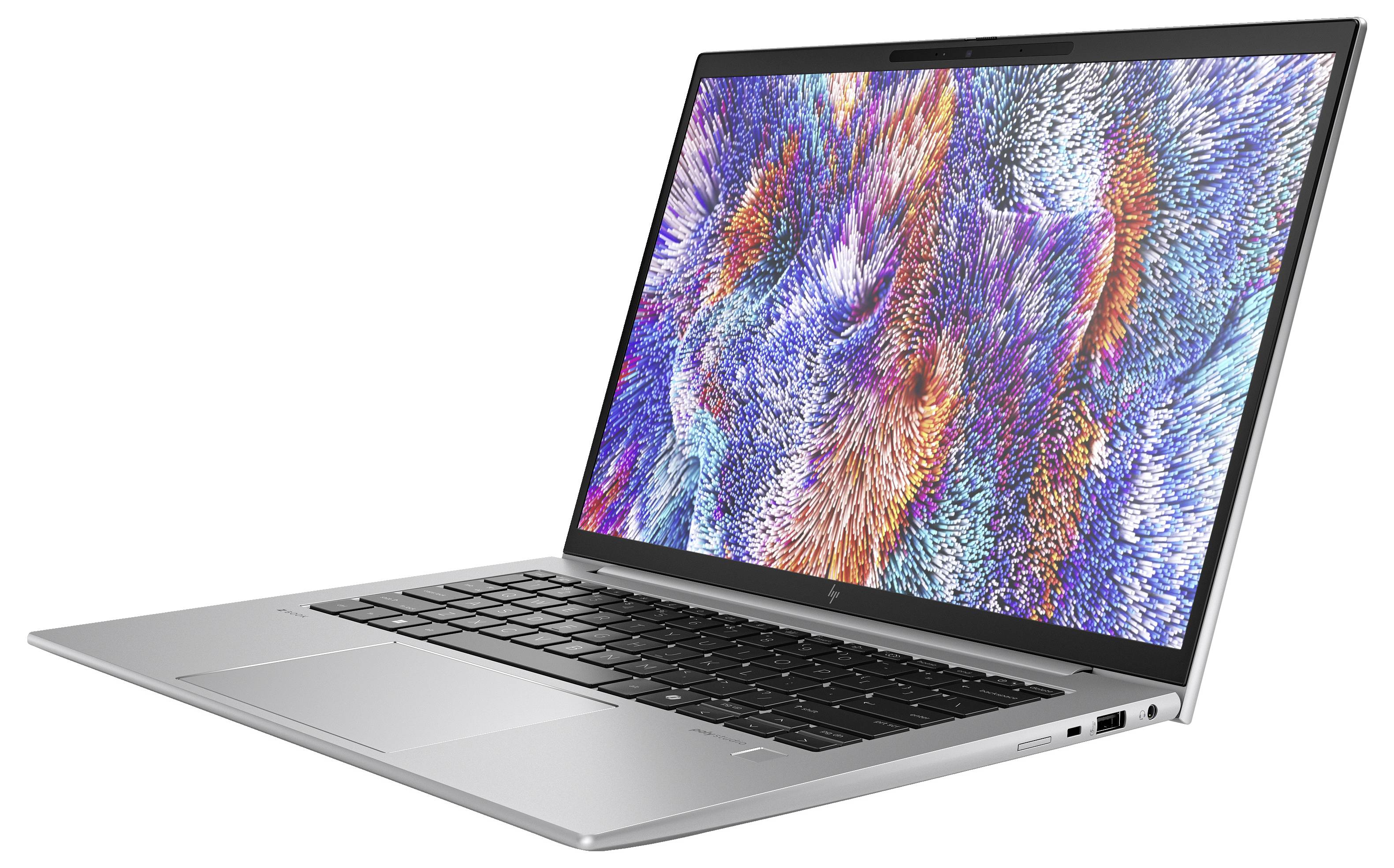 Ein moderner Laptop mit farbenfrohem, abstraktem Muster auf dem Bildschirm. Silbernes Gehäuse mit schwarzer Tastatur, in seitlicher Ansicht.