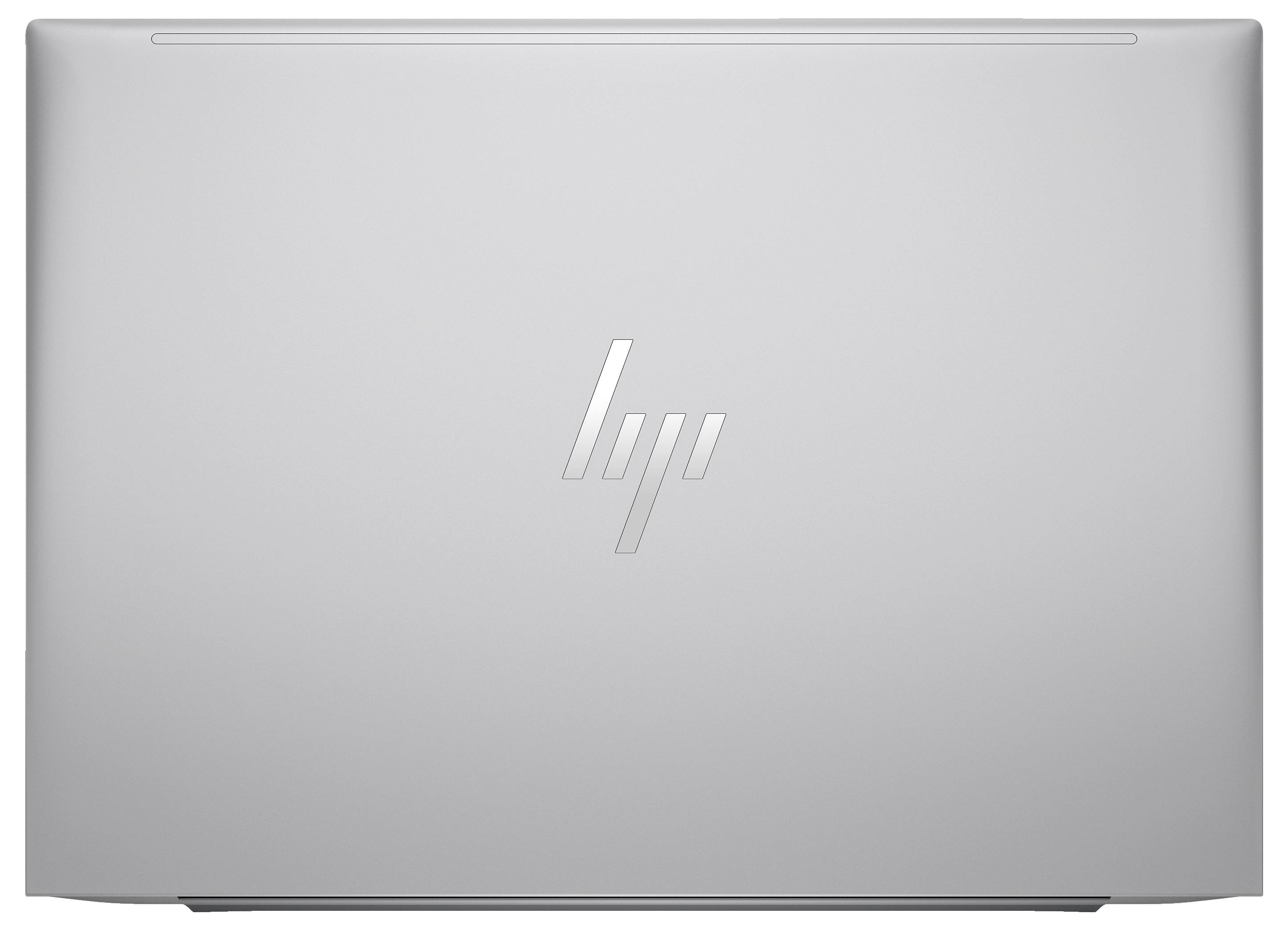 Geschlossener Laptop mit glänzendem Logo in der Mitte des Deckels auf silbernem Hintergrund.