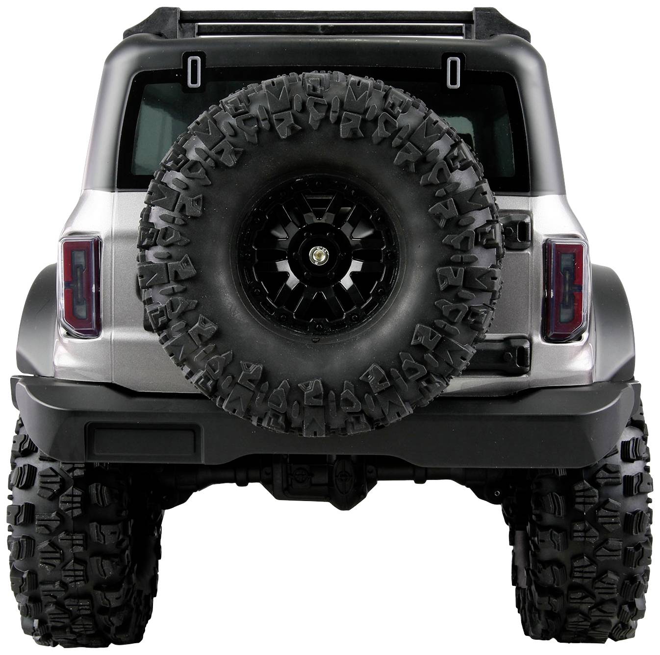 Ein silberner Geländewagen von hinten, mit großem Reserverad an der Rückseite, präsentiert sich bereit für Offroad-Abenteuer.