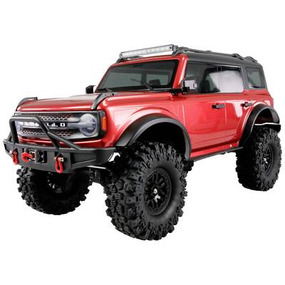 Ein roter Geländewagen mit großen, grobstolligen Reifen und einer Dachleiste mit Lichtern, dargestellt in einer dynamischen Position.