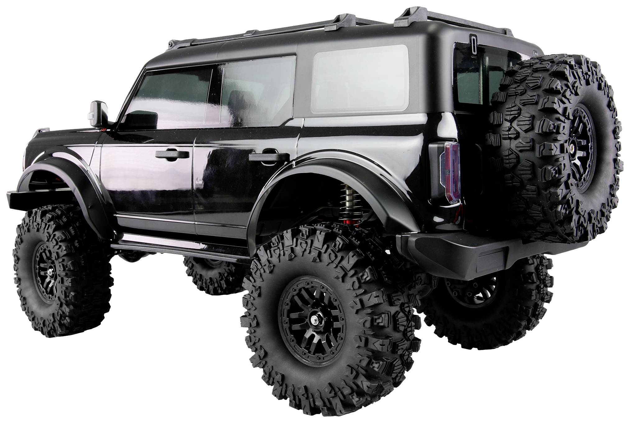 Großes, schwarzes Geländefahrzeug mit hoher Bodenfreiheit, großen Offroad-Reifen und zwei Reserverädern hinten, seitliche Ansicht.
