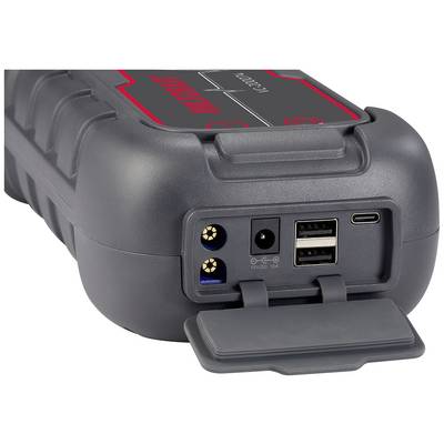 Ein tragbares, graues Ladegerät mit mehreren Anschlüssen: zwei USB, ein runder Stromanschluss und ein USB-C-Anschluss vorne.