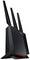 Schwarzer Router mit drei Antennen, steht vertikal auf einem Tisch. Gerät zeigt rote Lüftungsöffnung und LED-Anzeigen an der Vorderseite.