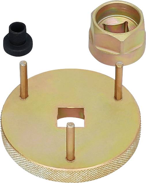 Ein goldfarbenes Werkzeug mit drei Stiften und quadratischer Öffnung, daneben eine schwarze Schraube und eine runde goldene Kappe.