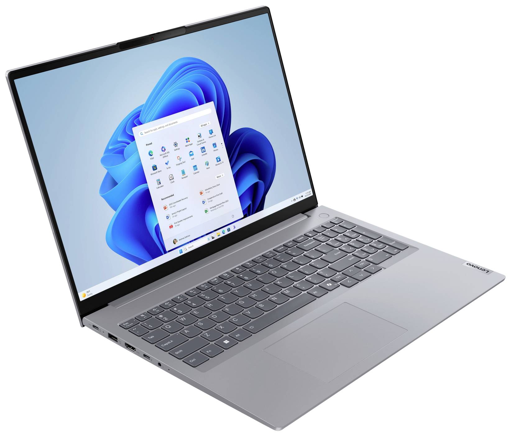 Ein geöffneter Laptop zeigt den Windows 11 Startbildschirm mit Symbolen und Taskleiste.