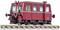 Ein roter, historischer Schienenbus auf einem Bahngleis, frontal leicht von der Seite gesehen. Es hat große Scheinwerfer und silberne Zierleisten.