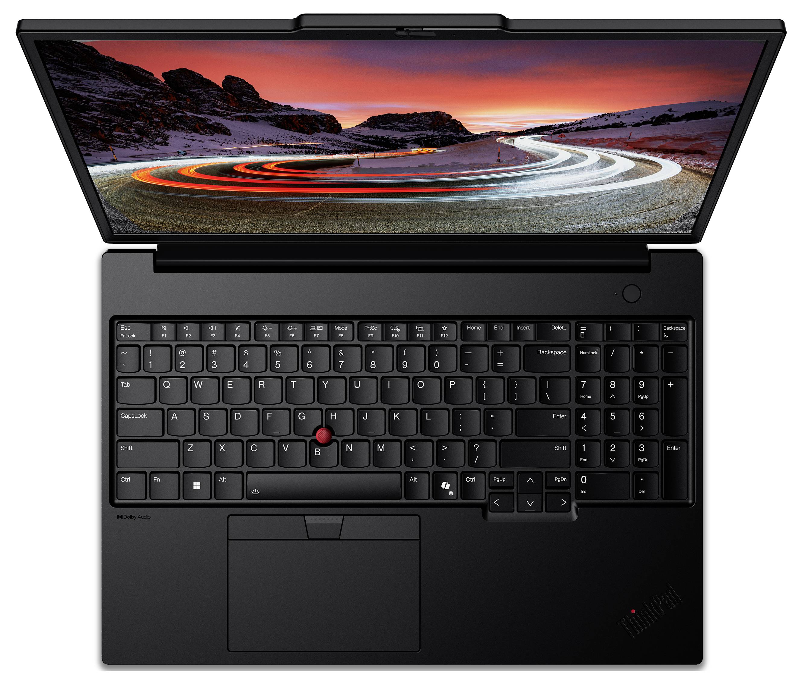 Ein geöffneter Laptop zeigt eine beleuchtete Tastatur und einen Bildschirm mit einem Bild von kurvenreichen Straßen bei Sonnenuntergang.