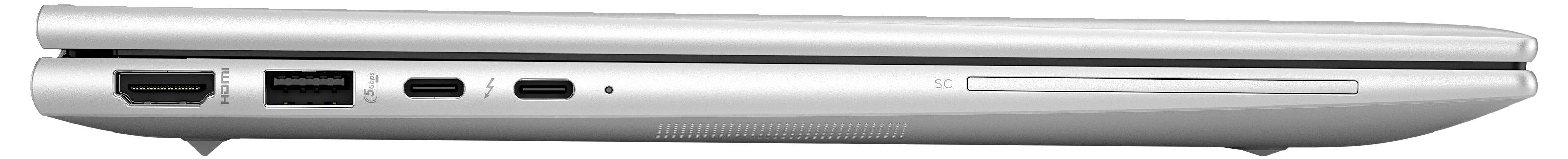 Ein geschlossenes silbernes Laptop von der Seite mit sichtbaren Anschlüssen und Laufwerk.