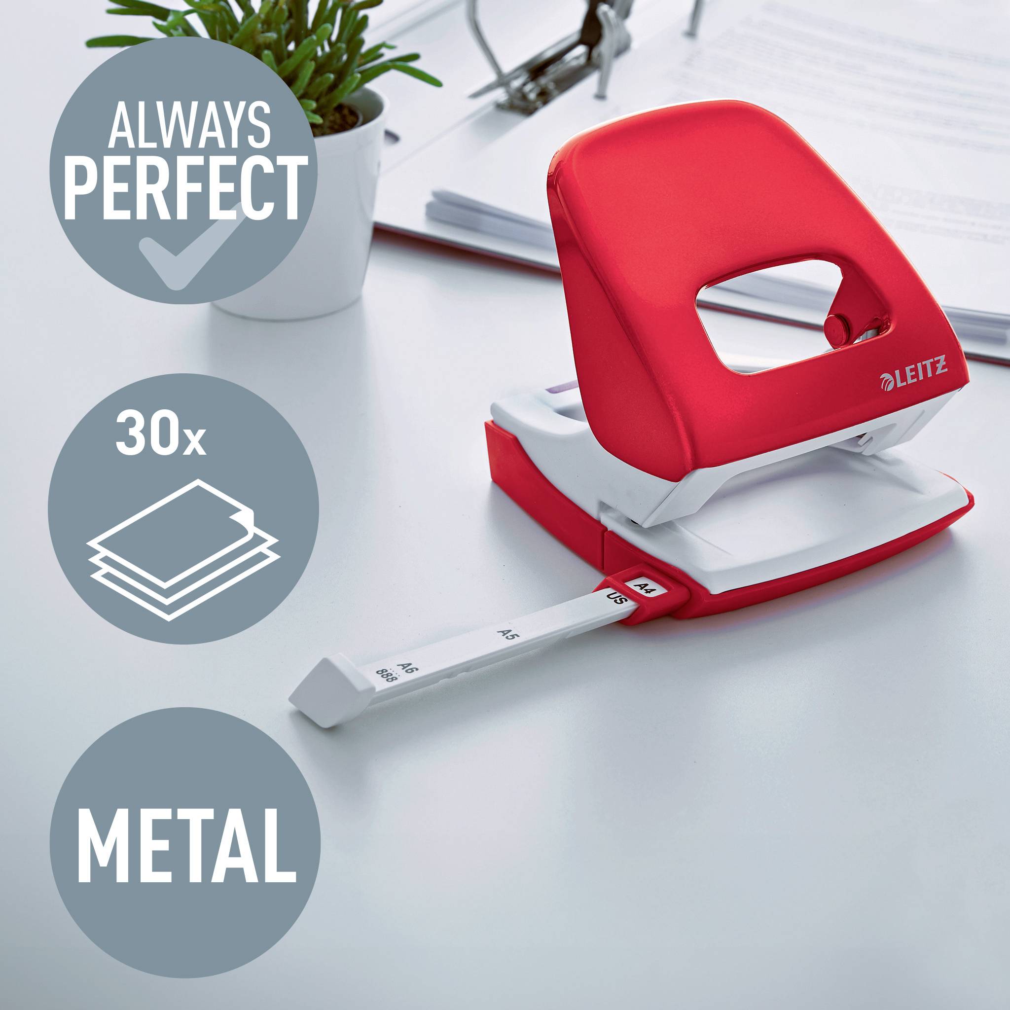 Ein roter Locher auf einem Schreibtisch, daneben ein Topfpflanze. Text im Bild: 'Always perfect', '30x', 'Metal'.