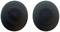 Zwei schwarze, runde, flache Objekte mit perforierten Mustern in der Mitte, möglicherweise Lautsprecherabdeckungen.