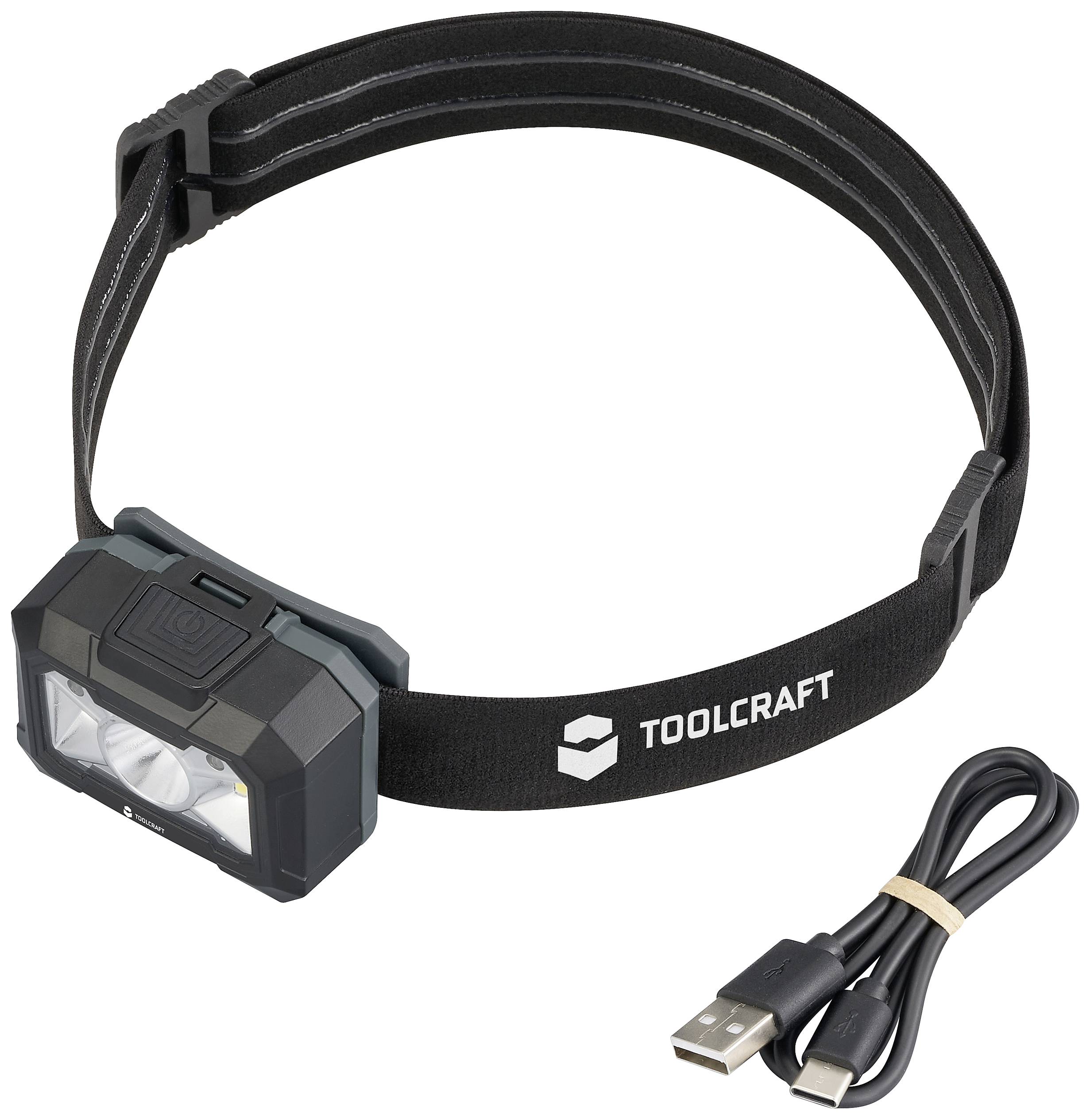 Kopflampe mit schwarzem Band und zwei LEDs, markiert mit 'Toolcraft'. Daneben liegt ein USB-Ladekabel.