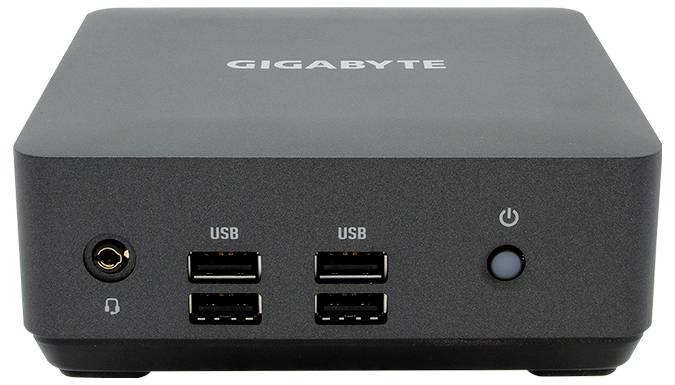 Ein rechteckiger, grauer Mini-PC mit vier USB-Ports, einem Kopfhöreranschluss und einem Einschaltknopf auf der Vorderseite.