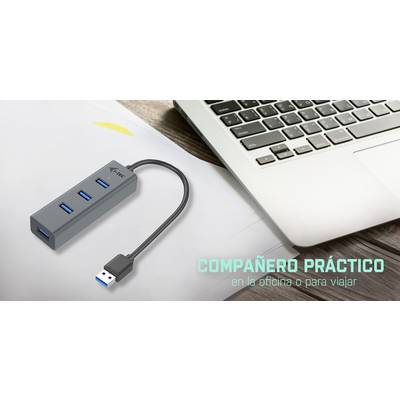 Ein USB-Hub mit vier Ports neben einem Laptop. Text auf Spanisch: 'Compañero práctico en la oficina o para viajar'.