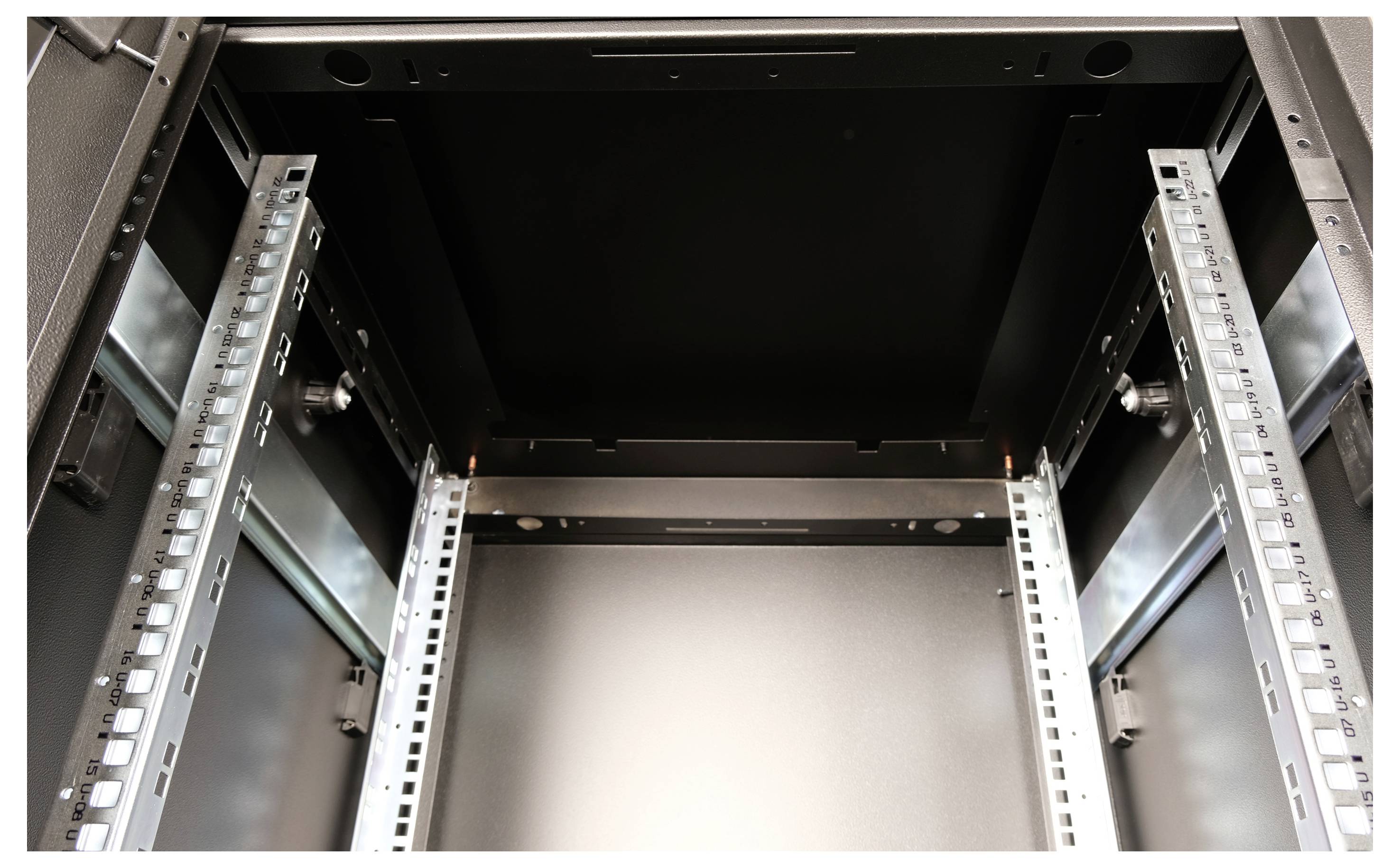 Leerer Server-Rack mit Sicht auf Schienen und Rahmen, bereit zur Aufnahme von IT-Ausrüstung in einem Rechenzentrum.