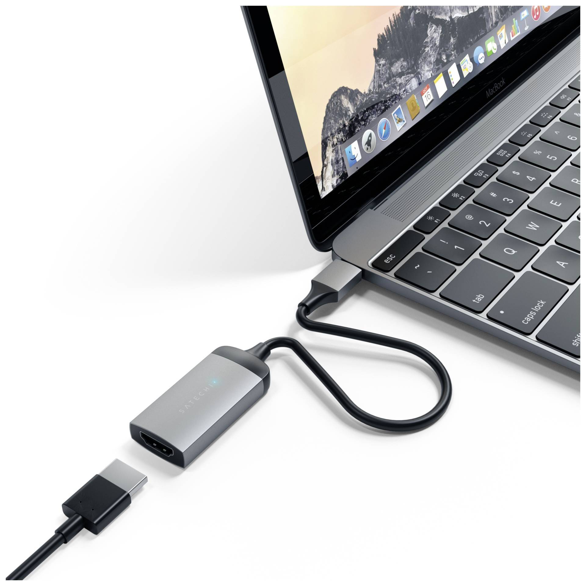 Ein Laptop ist mit einem Adapter verbunden, der über USB-C an den Laptop angeschlossen ist. Ein weiteres Kabel liegt daneben.