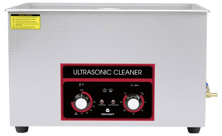 Ultraschallreiniger aus Metall mit Bedienfeld. Zwei Drehknöpfe für Timer und Temperatur. Etikett mit Bedienhinweisen oben links.