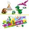 'LEGO' Spielset mit Dinosauriern und Vulkan. Oben grüne Dinosaurierfiguren und Vulkanbauwerk. Unten Anleitungsbuch mit bunten Illustrationen.