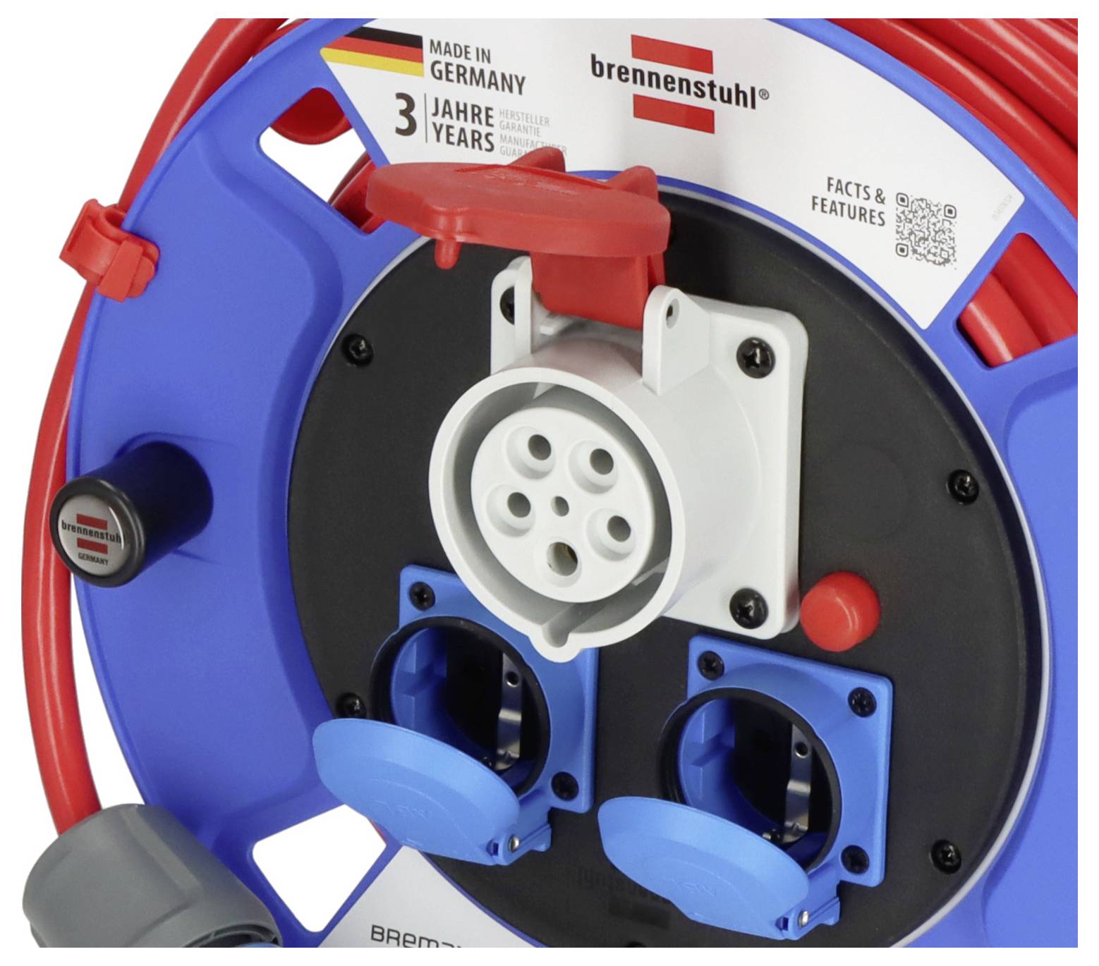 Blaues Kabeltrommelgehäuse mit rotem Kabel, zwei blauen Steckdosen, einer roten Klappe. 'Made in Germany', 3 Jahre Garantie.