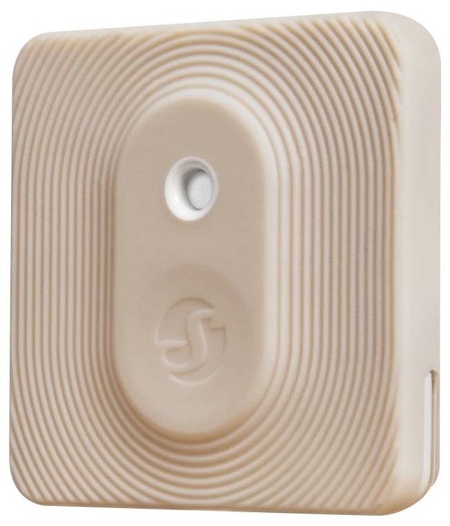 Beigefarbener rechteckiger Sensor mit kreisförmigen Rillen und einem zentralen Knopf. Geeignet für Innenräume zur Luftüberwachung.