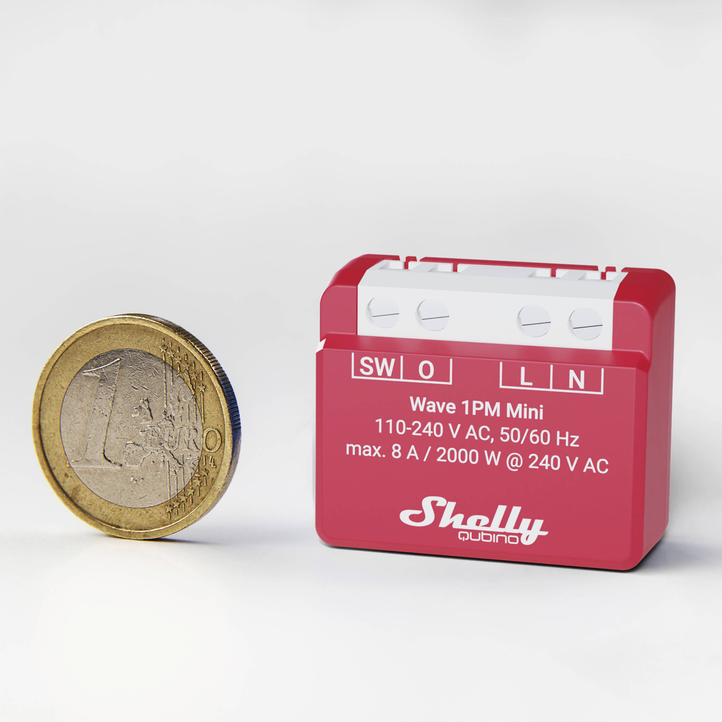 Ein rotes elektrisches Modul mit Aufschrift 'Wave 1PM Mini' neben einer 1-Euro-Münze, die Größenverhältnis zeigt.