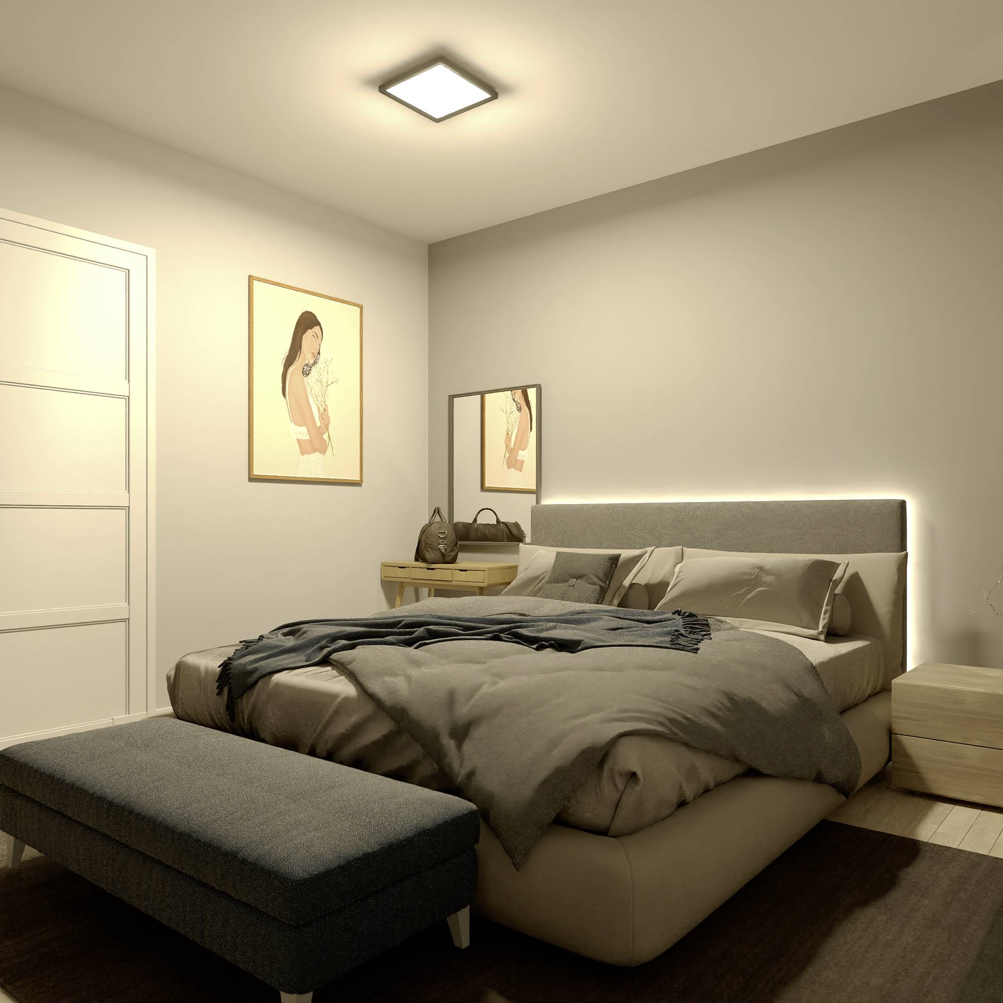 Ein Schlafzimmer mit einem großen Bett, grauer Decke, und Kissen. Ein Nachttisch mit Lampe links; an der Wand zwei Gemälde.