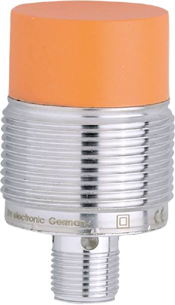 Ein orangefarbener Zylinder mit einem metallischen, gerippten Sockel. Es ist ein mechanischer Teil, möglicherweise ein Schalter.