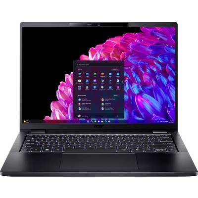 Ein geöffneter Laptop mit leuchtendem Bildschirm. Auf dem Bildschirm ist der Startmenü von Windows zu sehen. Der Hintergrund ist ein buntes Blumenmuster.