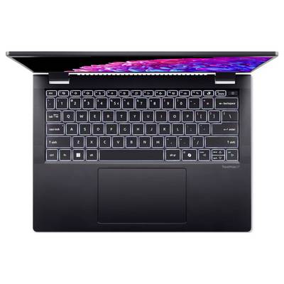 Ein aufgeklappter Laptop mit leuchtender Tastatur und teilweisem Blick auf den Bildschirm. Die Tasten haben ein qwerty-layout.