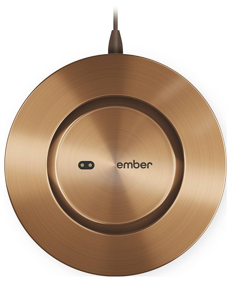 Kupferfarbene Ladeunterlage mit 'ember'-Logo in der Mitte, angeschlossen an ein Kabel.