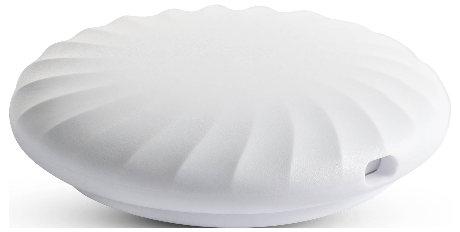 Ein weißes, rundes Gerät mit geripptem Design. Es hat eine kleine Öffnung an der Seite.