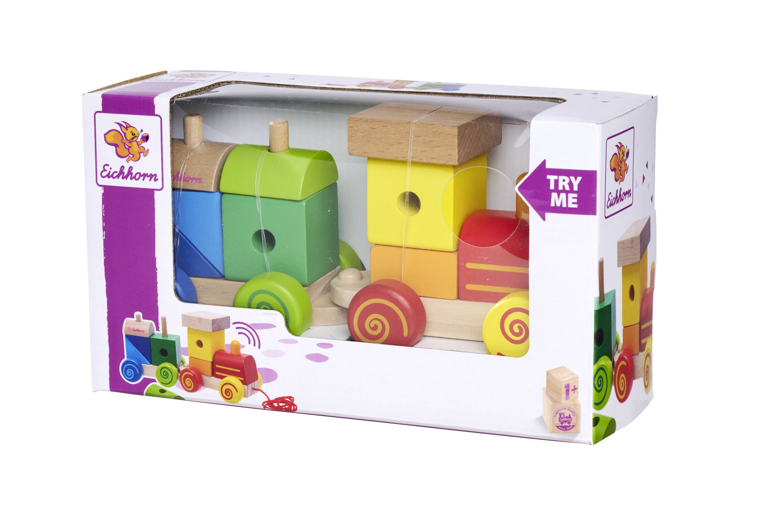 Spielzeug-Holzeisenbahn in bunter Verpackung mit Aufschrift 'Try Me'. Enthält Lokomotive mit zwei Waggons, farbenfroh gestaltet.