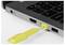 Nahaufnahme eines Laptops mit einem gelben USB-Sicherheitsschlüssel, der in einen seitlichen Anschluss eingesteckt ist.