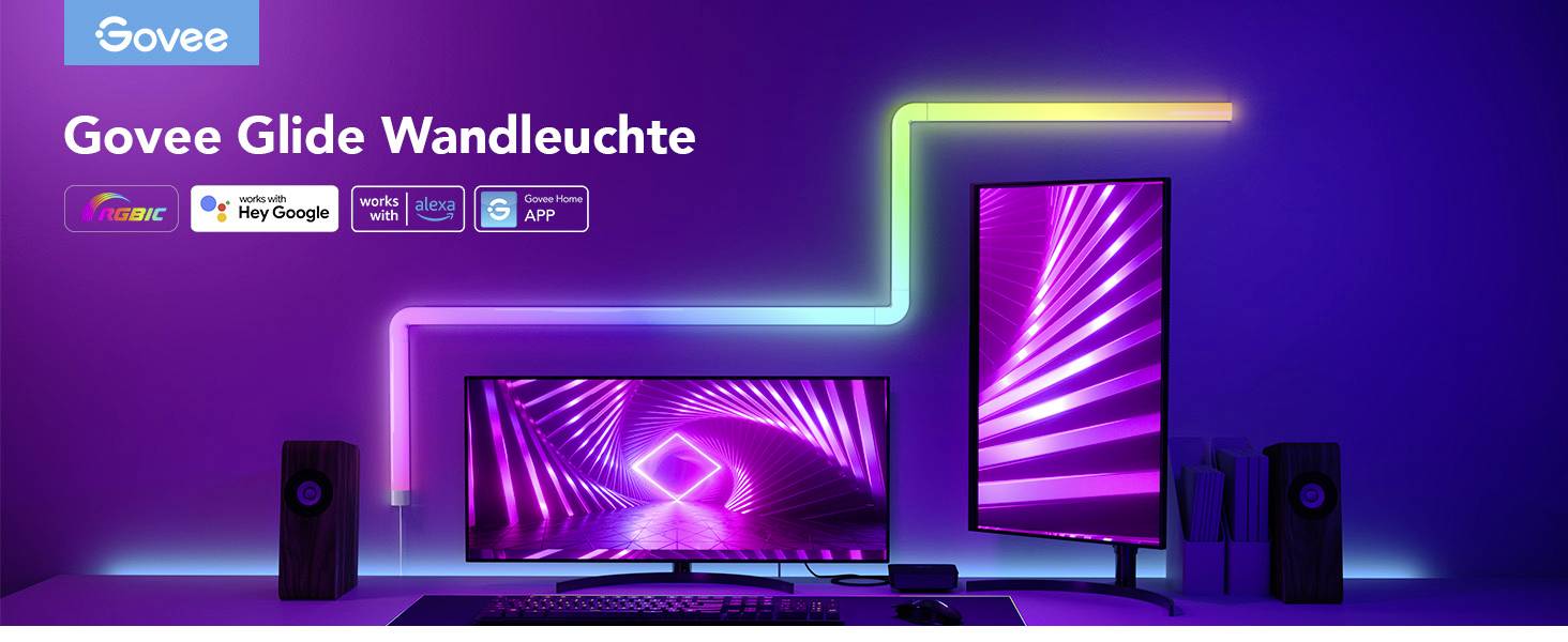 'Govee Glide Wandleuchte' Anzeige mit leuchtenden LED-Streifen in einem Raum, monitoren und Lautsprechern. Text: Funktioniert mit Alexa, Google.
