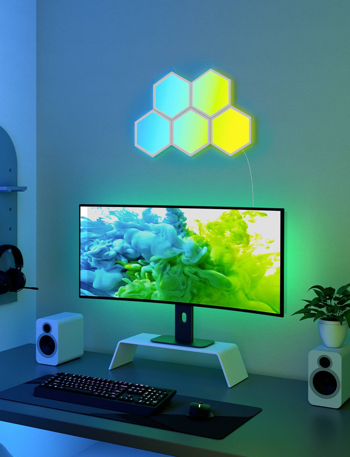 In einem modernen Büro zeigt ein Schreibtisch einen Monitor mit farbenfroher Grafik, darunter Tastatur und Lautsprecher, im blauen Licht.
