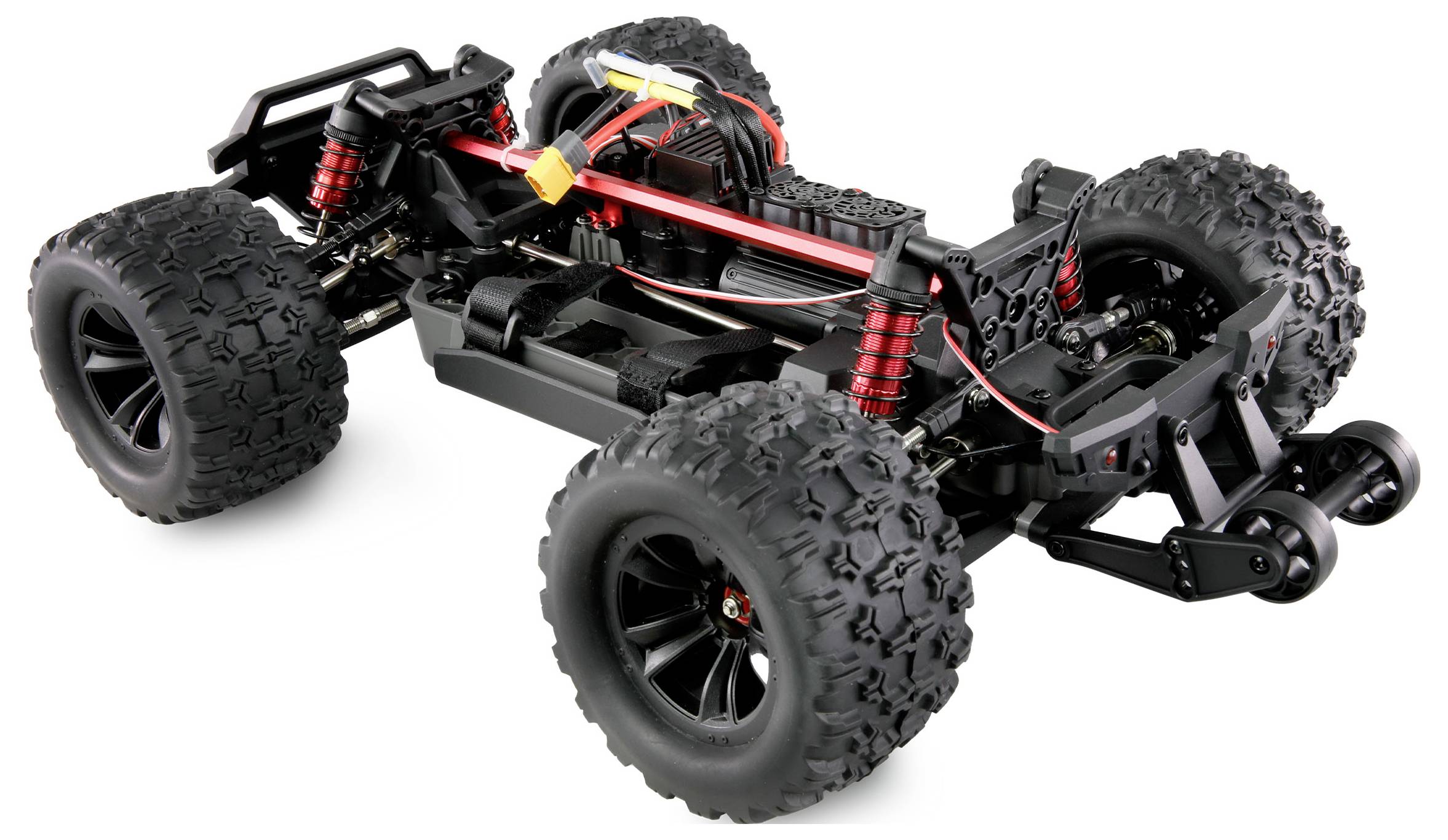 Modell eines RC-Trucks ohne Karosserie, zeigt detaillierte Ansicht des Fahrgestells mit großen, geländetauglichen Reifen und Stoßdämpfern.