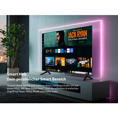 Der Fernseher zeigt den Bildschirm 'Smart Hub' mit mehreren App-Symbolen. Oben ist ein Bild der Serie 'Jack Ryan' zu sehen.