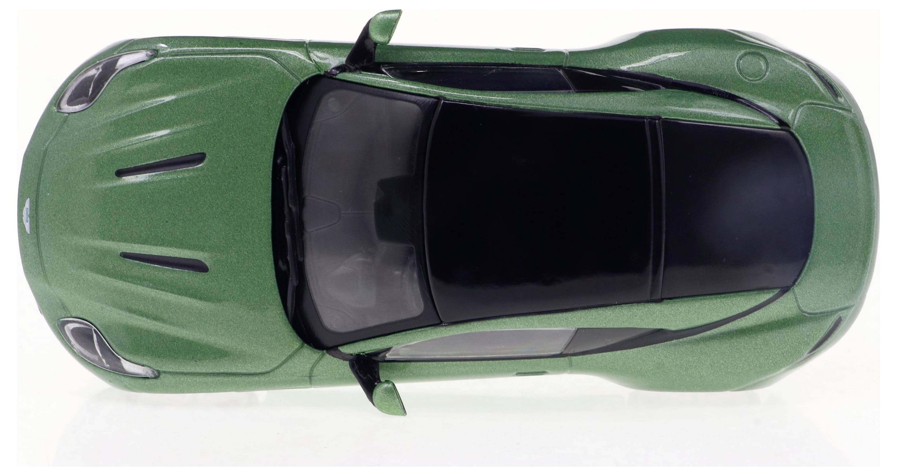 Ein grünes Spielzeugauto von oben, mit schwarzem Dach und geformten Details.