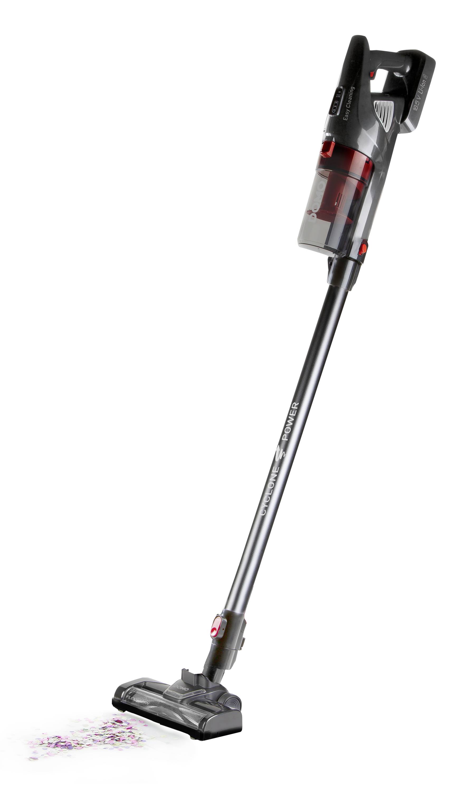 Stabstaubsauger mit rotem Behälter reinigt bunten Konfettistaub vom Boden.