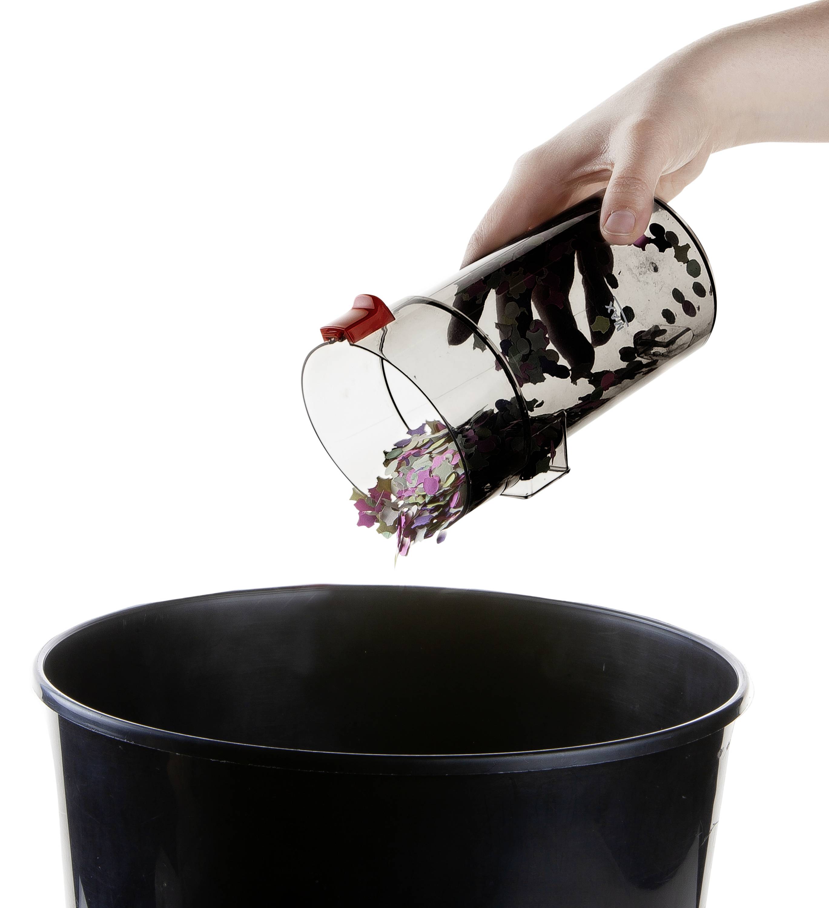 Eine Hand leert einen transparenten Behälter mit farbigen Blättern in einen schwarzen Mülleimer.