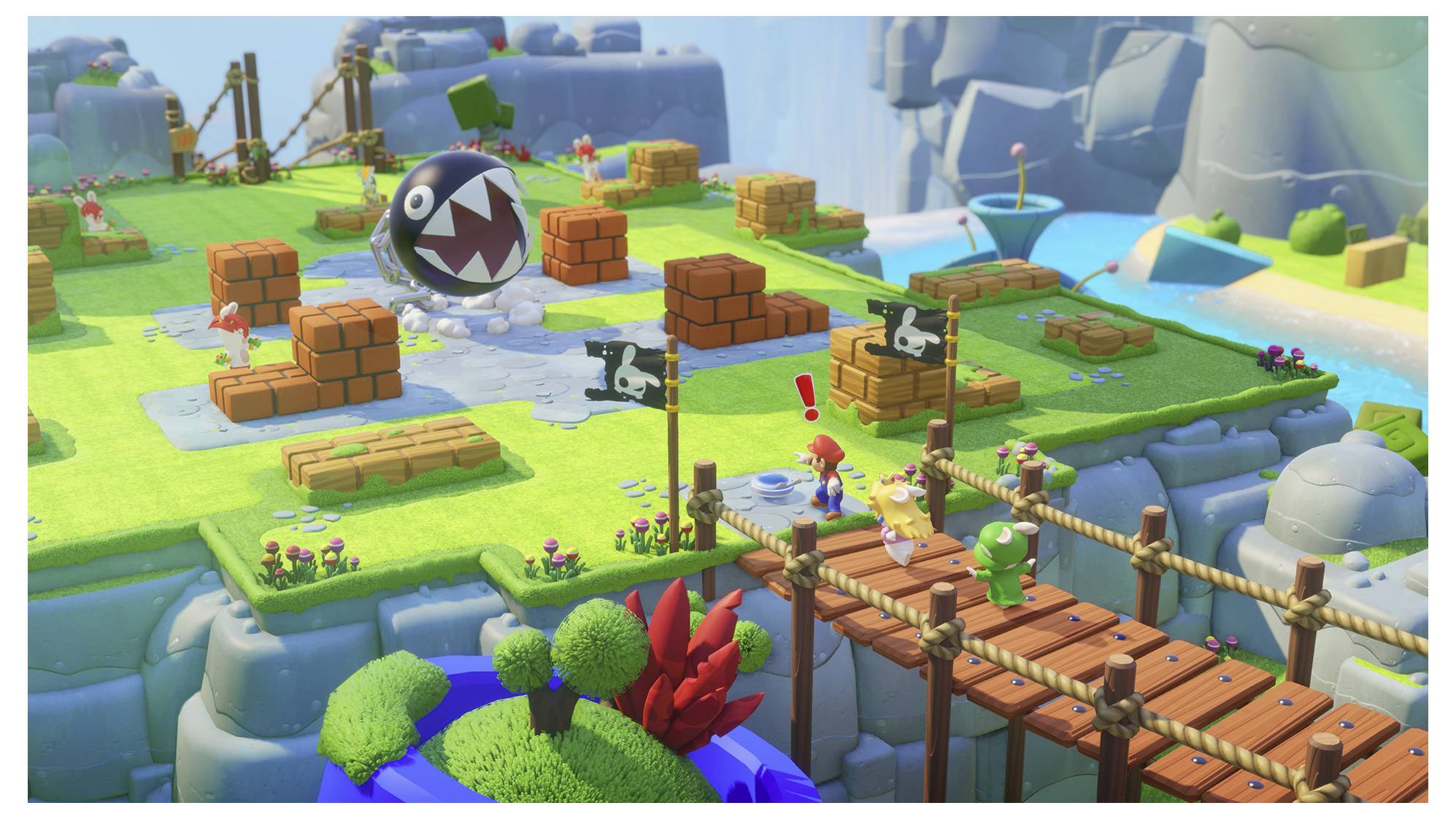 Ein Videospiel-Screenshot zeigt Figuren auf einer bunten, blockartigen Landschaft mit Brücken, Steinen und einem großen Kettenhund.