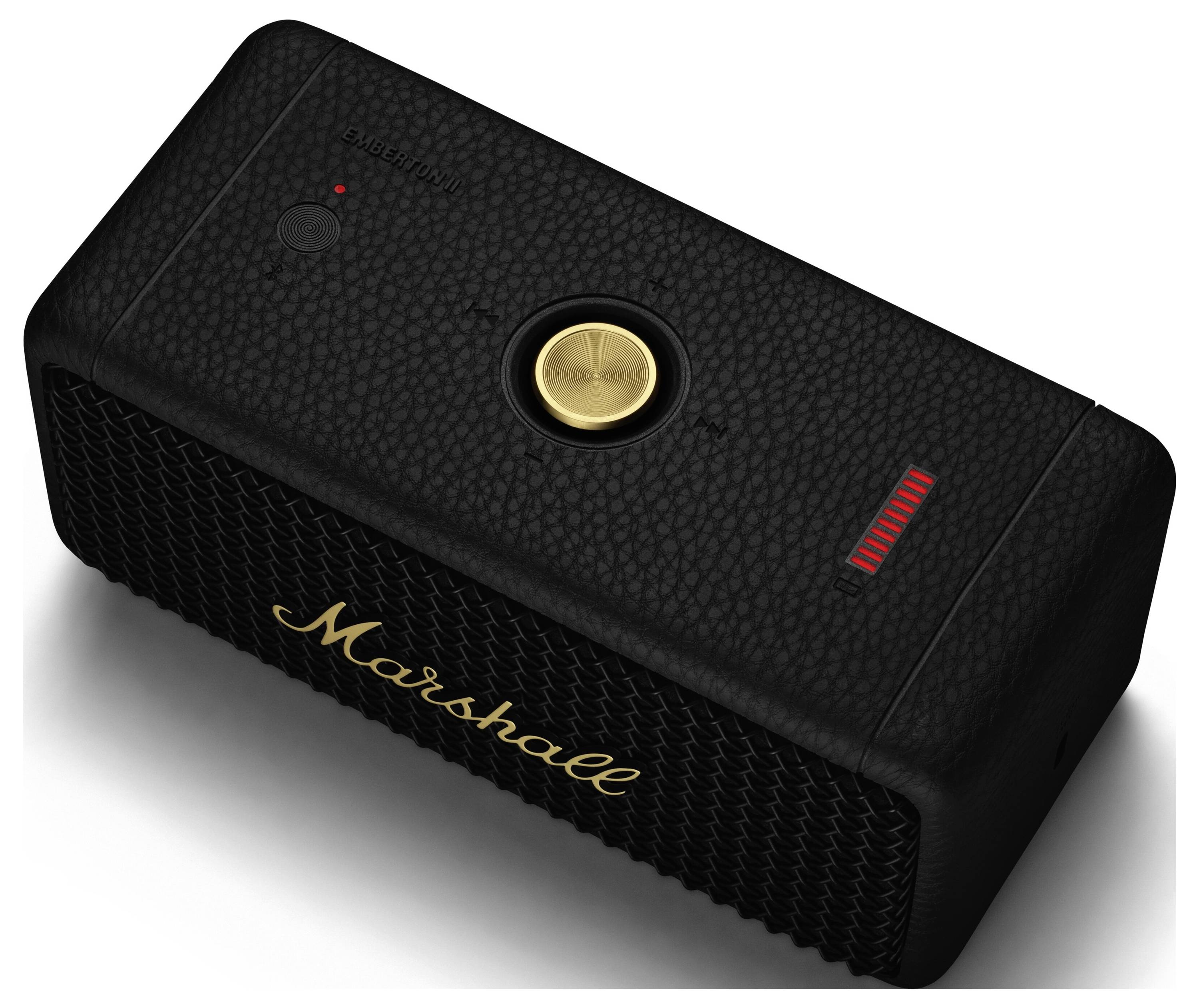 Schwarzer tragbarer Lautsprecher mit goldfarbenem Kreisknopf in der Mitte, Markenlogo in Gold, LED-Anzeigen für Akku und Bluetooth.