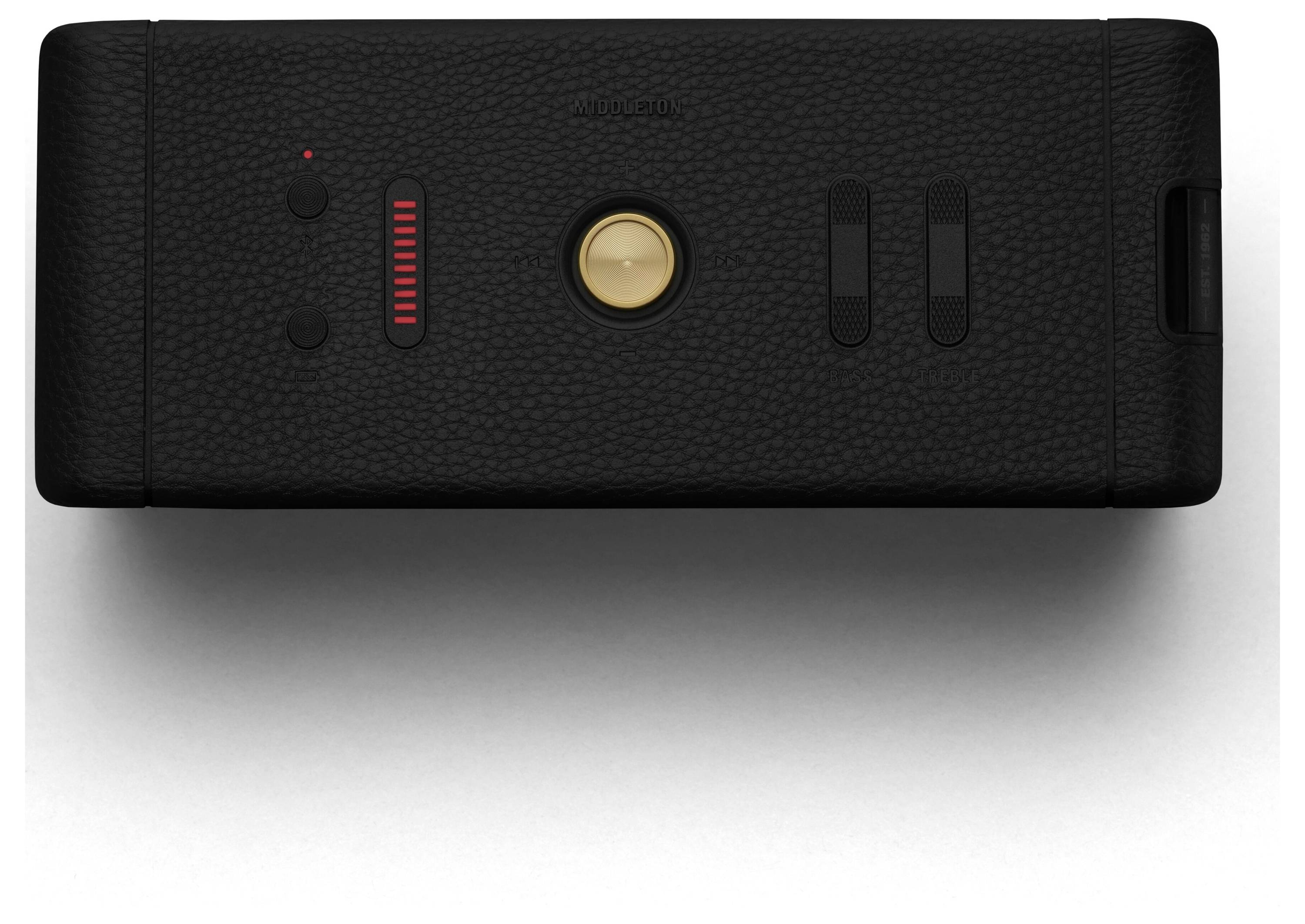 Ein schwarzes, rechteckiges Gerät mit texturierter Oberfläche, einem zentralen runden goldenen Knopf und mehreren Schiebereglern.