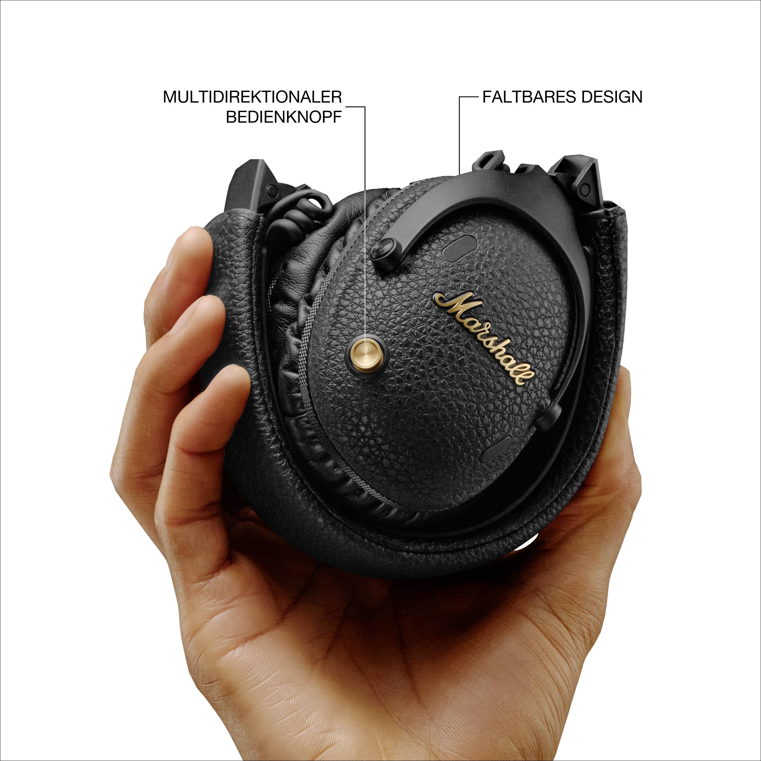 Eine Hand hält einen zusammengeklappten Kopfhörer mit der Aufschrift 'Marshall'. Hervorgehobene Merkmale sind ein Drehknopf und das faltbare Design.