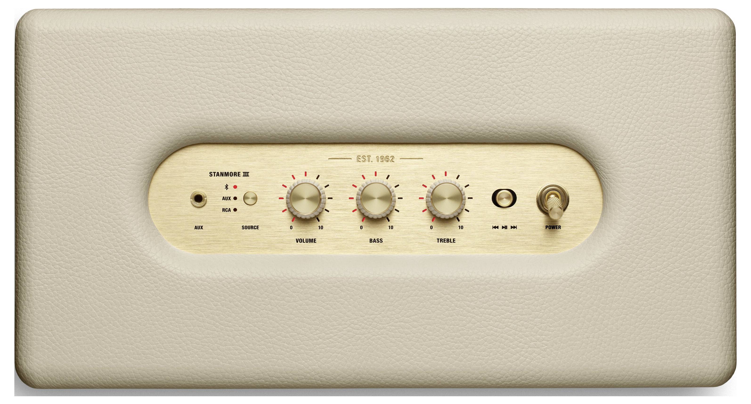 Ein cremefarbener Lautsprecher mit goldener Bedienoberfläche zeigt Regler für Lautstärke, Bass, Höhen, einen Kippschalter und Buchsen.